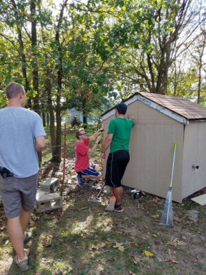 Church Youth repairing lawn shed backside
