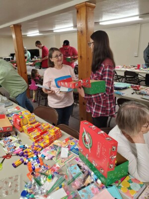 Youth volunteers filling Operation Christmas Child shoe boxes