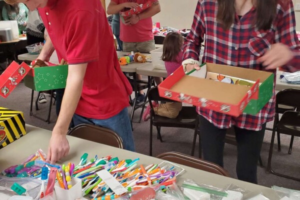 Church volunteers filling Operation Christmas Child shoe boxes