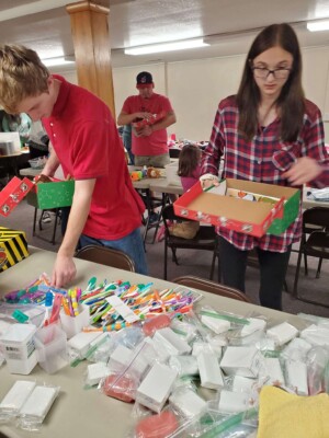 Church volunteers filling Operation Christmas Child shoe boxes