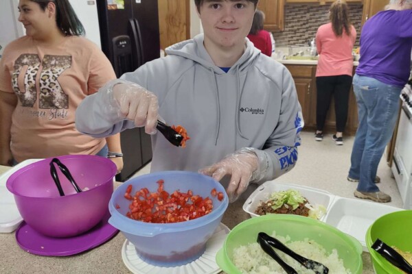 Youth helping serve dinner during colcord church fundraiser