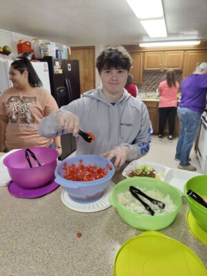 Youth helping serve dinner during colcord church fundraiser