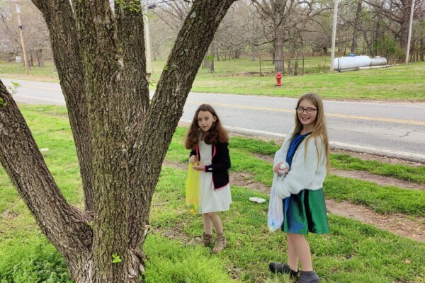 Two kids hunting eggs at the First Baptist Church Easter egg hunt