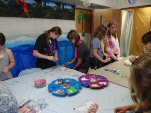 Kids participating in VBS crafts in the old church basement