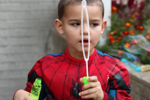 Kid blowing bubbles by the church