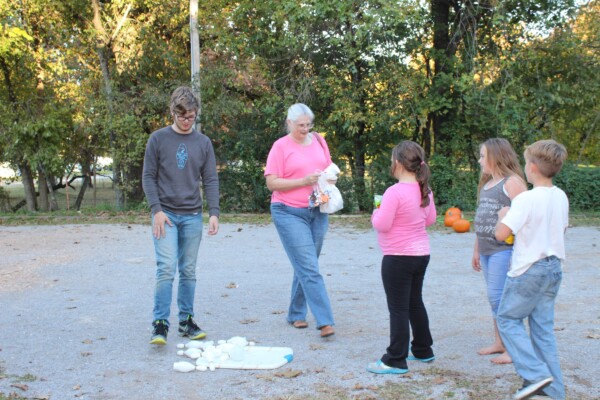 Children bowling as an outdoor recreational activity in church yard